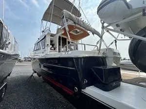 Slide: The Image of 2022 Cutwater C-32 CB boat docked, showcasing sleek design and spacious deck. - 5