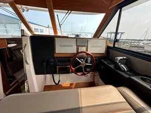 Slide: The Image of 2022 Cutwater C-32 CB helm with Garmin displays and wooden steering wheel. - 7