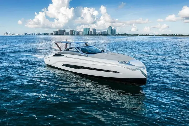 Slide: The Image of Luxury Tecnomar Evo 55 yacht cruising on open water, 2017 model, with city skyline backdrop. - 19