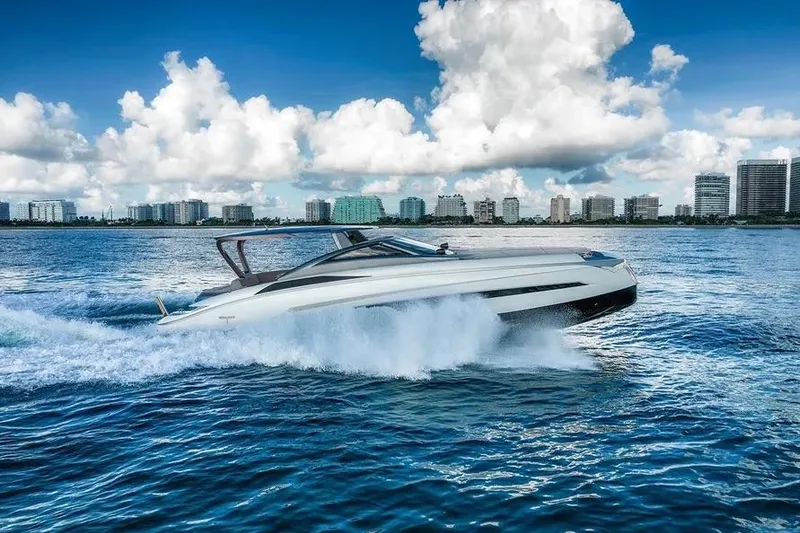 Slide: The Image of Luxury Tecnomar Evo 55 yacht cruising on blue ocean near city skyline, 2017 model. - 22