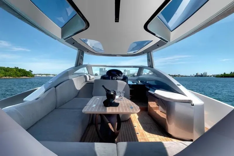 Slide: The Image of Luxurious Tecnomar Evo 55 yacht interior with panoramic views, modern seating, and elegant table setting. - 9