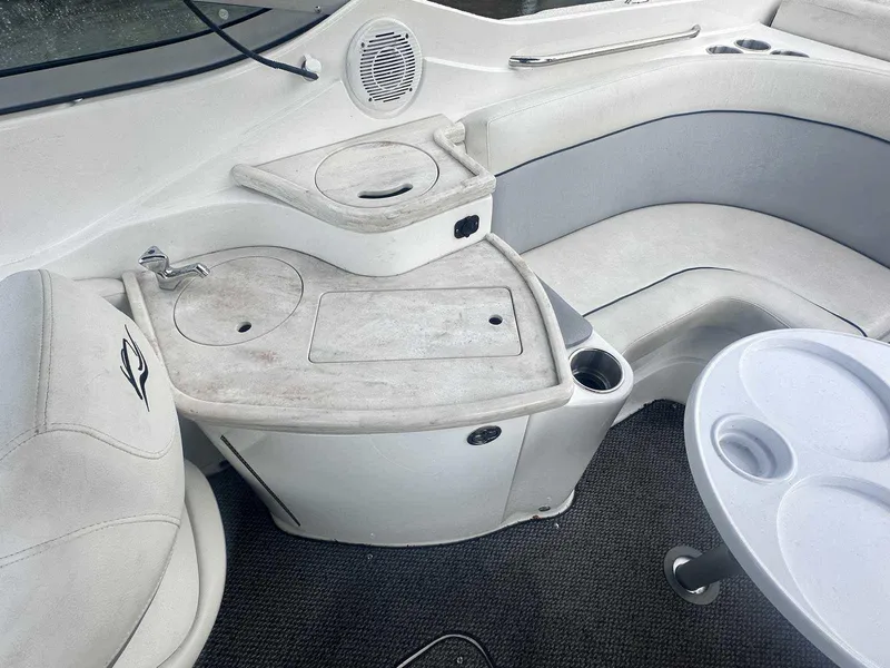 Slide: The Image of 2015 Rinker 276 Captiva Bowrider interior with seating, sink, and table. - 17