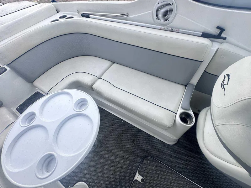 Slide: The Image of 2015 Rinker 276 Captiva Bowrider interior with seating and table setup. - 19