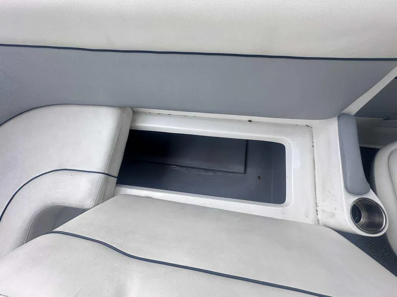 Slide: The Image of 2015 Rinker 276 Captiva Bowrider interior storage compartment with cup holder. - 20