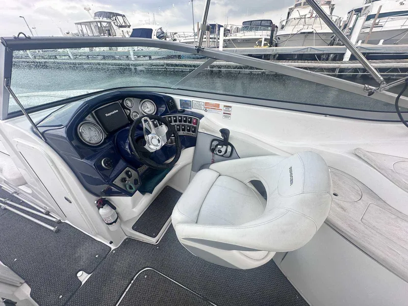 Slide: The Image of 2015 Rinker 276 Captiva Bowrider cockpit with steering wheel and control panel. - 21