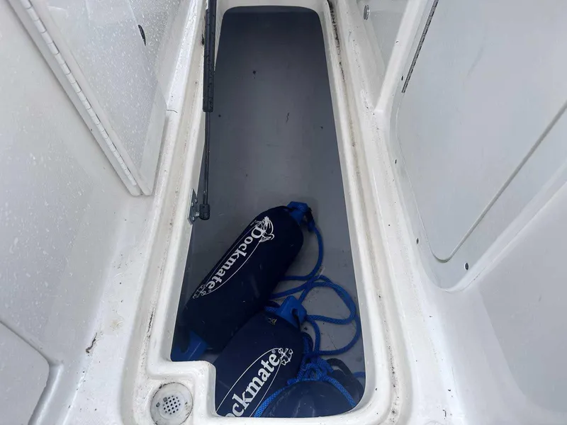 Slide: The Image of Storage compartment of 2015 Rinker 276 Captiva Bowrider with dock fenders and ropes. - 27