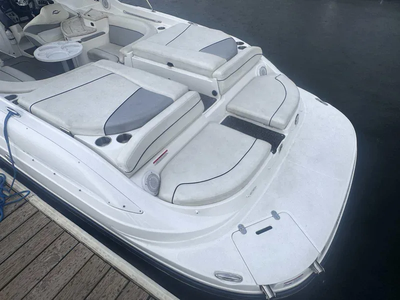 Slide: The Image of 2015 Rinker 276 Captiva Bowrider with spacious seating and sleek design at the dock. - 3