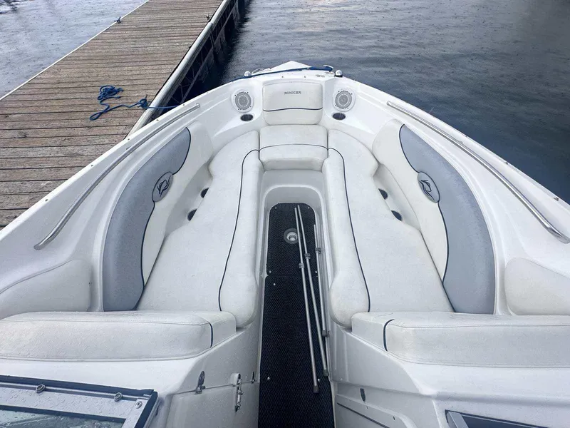 Slide: The Image of 2015 Rinker 276 Captiva Bowrider with white seating, docked by wooden pier. - 30