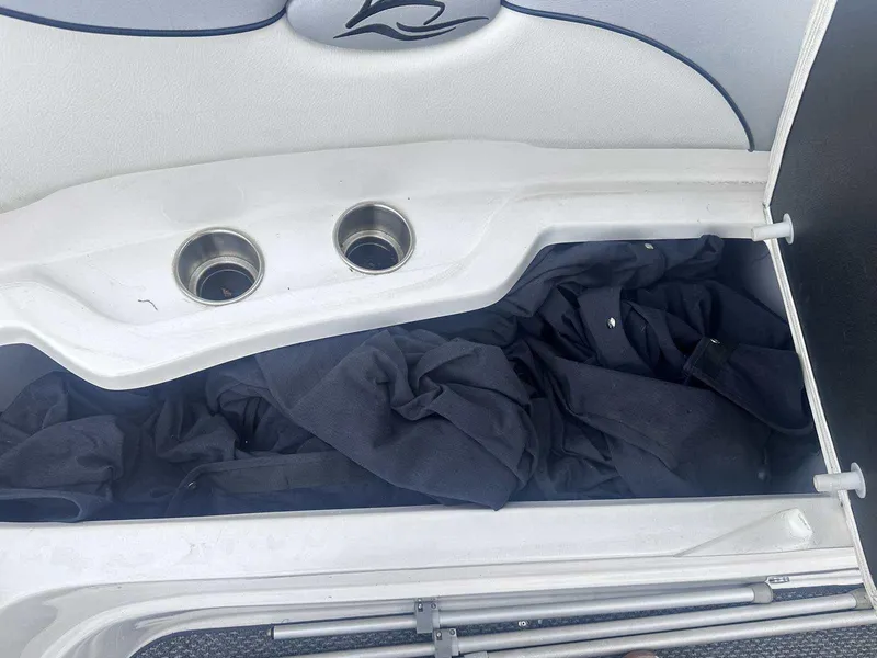 Slide: The Image of Storage compartment in a 2015 Rinker 276 Captiva Bowrider, containing black fabric. - 34