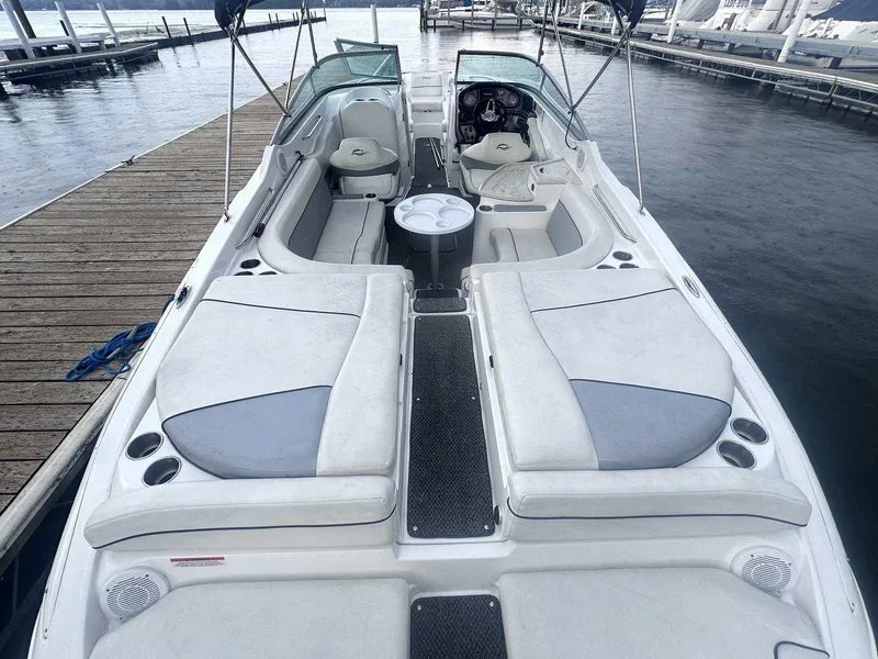 Slide: The Image of 2015 Rinker 276 Captiva Bowrider docked, featuring spacious seating and sleek design. - 4