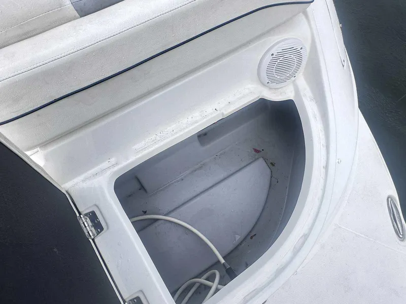 Slide: The Image of Open storage compartment on a 2015 Rinker 276 Captiva Bowrider boat. - 5
