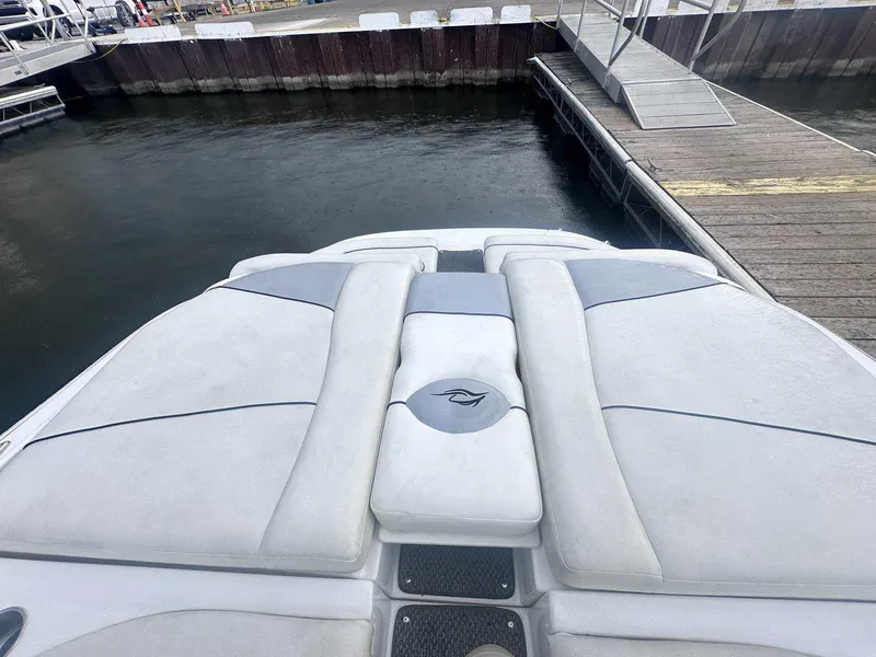 Slide: The Image of 2015 Rinker 276 Captiva Bowrider at dock, featuring spacious sunpad and sleek design. - 6