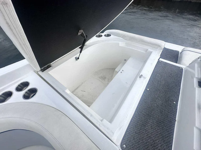 Slide: The Image of Open storage compartment on 2015 Rinker 276 Captiva Bowrider boat, near water. - 7