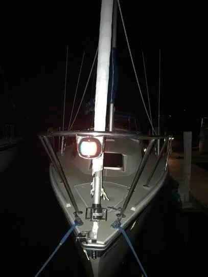Slide: The Image of 1987 O'Day 272 sailboat docked at night, front view with mast and ropes visible. - 10