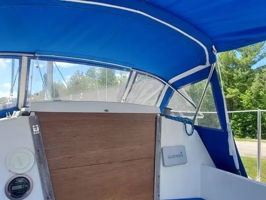 Slide: The Image of 1987 O'Day 272 sailboat cockpit with blue canopy and Garmin equipment. - 19