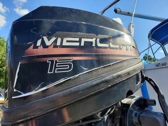 Slide: The Image of Outboard motor on 1987 O'Day 272 sailboat, featuring a Mercury 15 engine. - 36