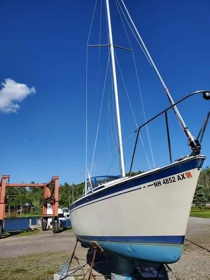 Slide: The Image of 1987 O'Day 272 sailboat on land, clear blue sky, marina background. - 6