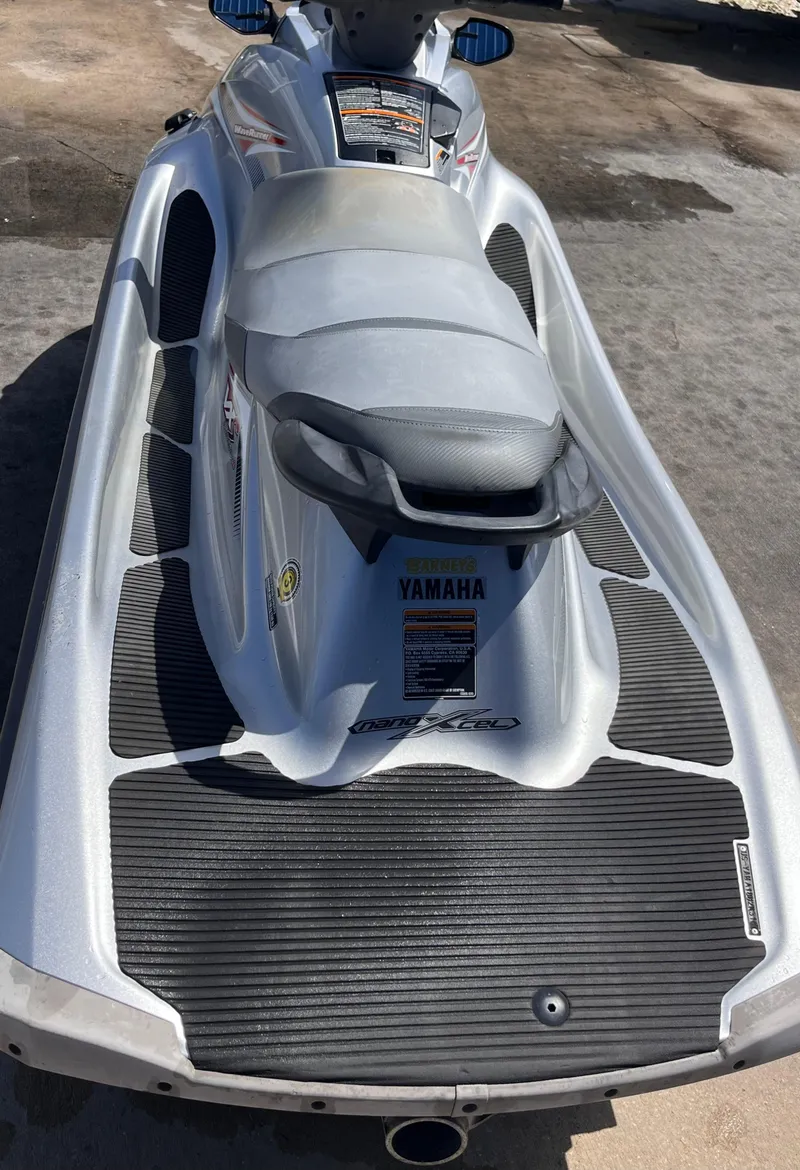Slide: The Image of 2014 Yamaha WaveRunner VXR jet ski, silver with black accents, parked on concrete. - 8