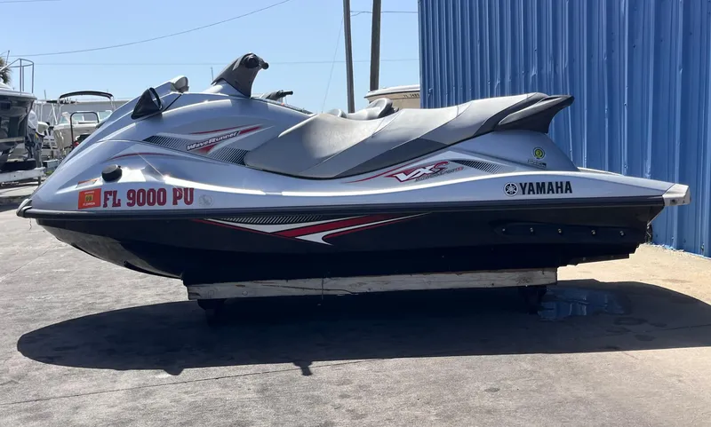 Slide: The Image of 2014 Yamaha WaveRunner VXR jet ski parked near blue building. - 9
