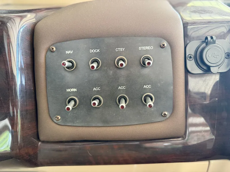 Slide: The Image of Control panel of a 2016 Coach Pontoons 25RF with labeled switches for various functions. - 10