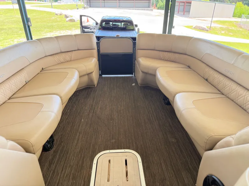 Slide: The Image of 2016 Coach Pontoons 25RF interior with beige seating and carpeted floor. - 12