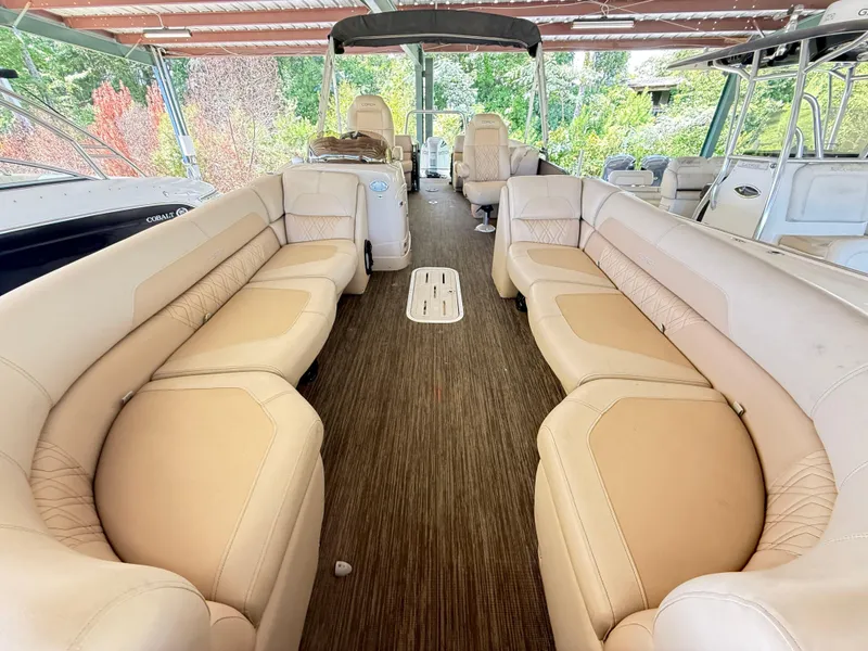 Slide: The Image of 2016 Coach Pontoons 25RF interior with beige seating and wood-style flooring. - 14