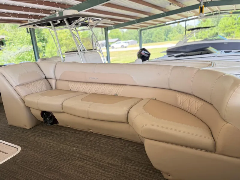 Slide: The Image of Luxurious seating on a 2016 Coach Pontoons 25RF boat under a covered dock. - 15