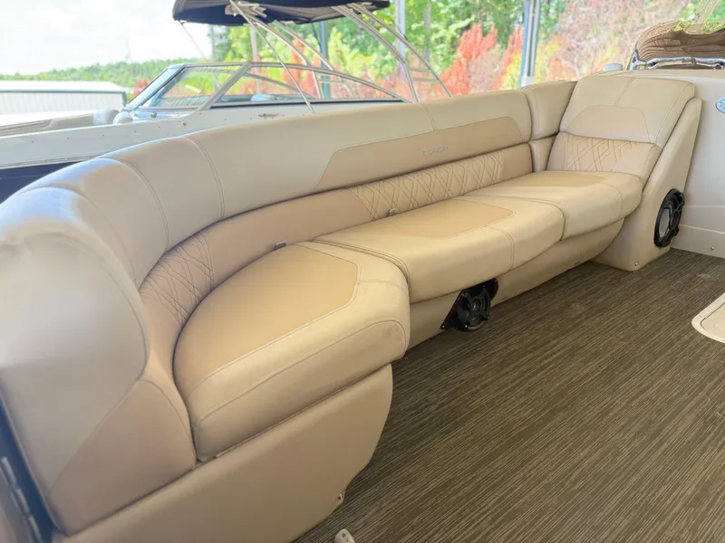 Slide: The Image of Luxurious seating on a 2016 Coach Pontoons 25RF boat, featuring beige upholstery and spacious design. - 16