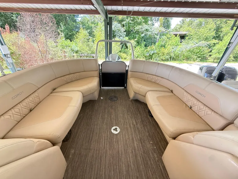 Slide: The Image of 2016 Coach Pontoons 25RF interior with beige seating and wood flooring. - 17