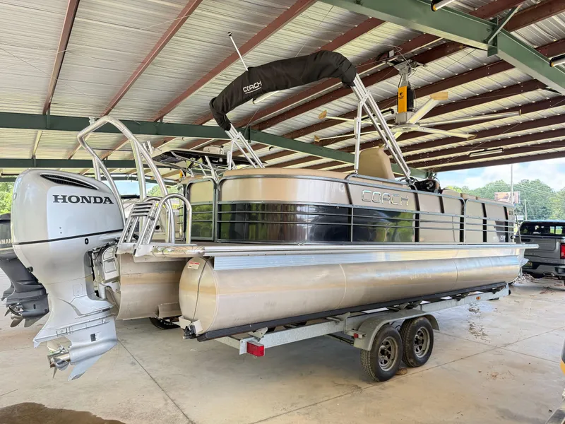 Slide: The Image of 2016 Coach Pontoons 25RF on trailer with Honda outboard motor in covered storage. - 3