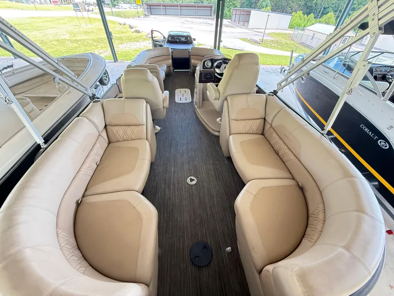 Slide: The Image of 2016 Coach Pontoons 25RF interior with luxurious beige seating and modern dashboard. - 5