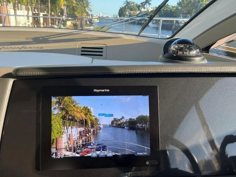 Slide: The Image of Dashboard view of a 2019 Schaefer 510 yacht with navigation display and compass. - 14