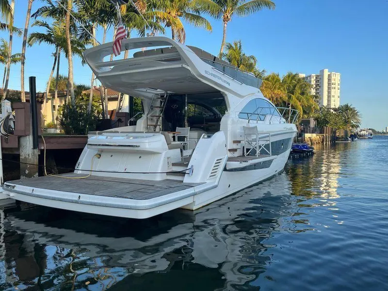 Slide: The Image of Luxury Schaefer 510 yacht docked by palm trees, 2019 model. - 2
