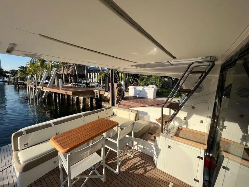 Slide: The Image of Luxurious 2019 Schaefer 510 yacht deck with seating and table, docked by waterfront. - 30