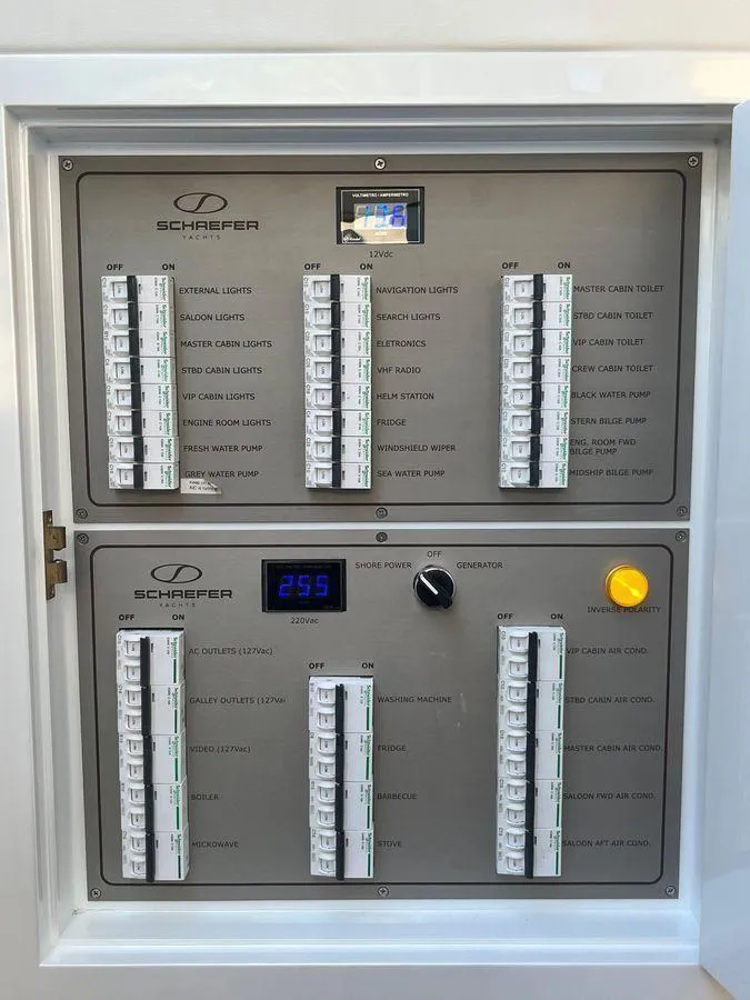 Slide: The Image of Electrical control panel of a 2019 Schaefer 510 yacht, featuring switches and voltage display. - 32