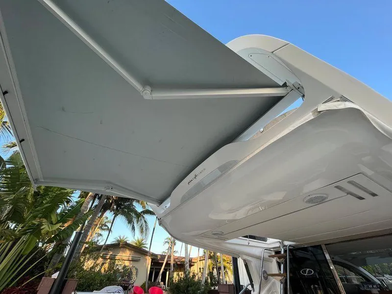 Slide: The Image of Schaefer 510 yacht awning, 2019 model, extended under clear blue sky. - 41