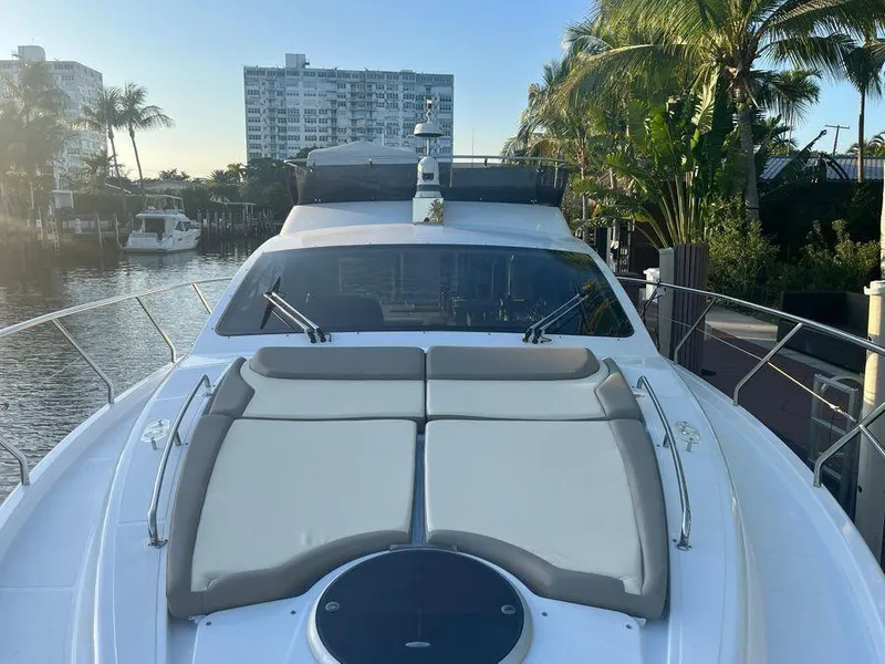 Slide: The Image of Luxury Schaefer 510 yacht docked, featuring spacious sunbathing area, surrounded by palm trees. - 47