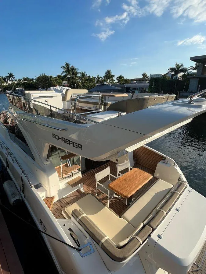 Slide: The Image of Luxurious 2019 Schaefer 510 yacht docked, featuring elegant outdoor seating and sleek design. - 8