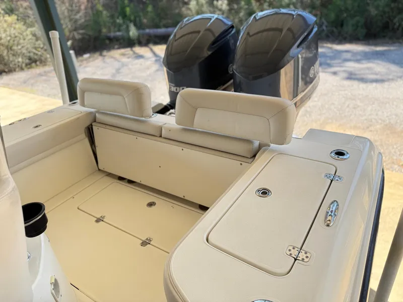 Slide: The Image of Interior of a 2013 Blackwood 27 boat with dual engines and beige seating. - 12