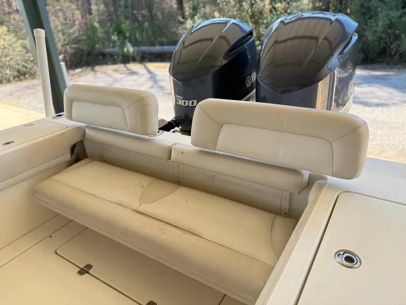 Slide: The Image of 2013 Blackwood 27 boat interior with dual Yamaha 300 engines, featuring beige seating. - 13