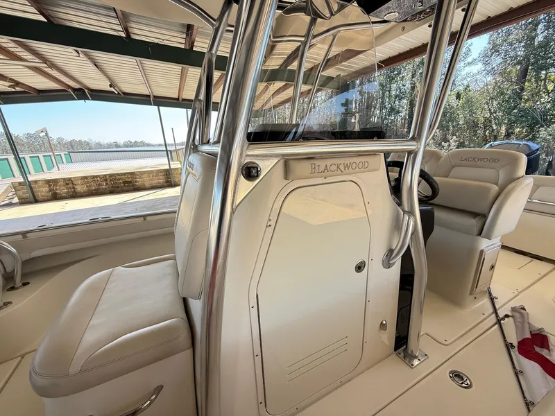 Slide: The Image of Interior of a 2013 Blackwood 27 boat with seating and steering console. - 16