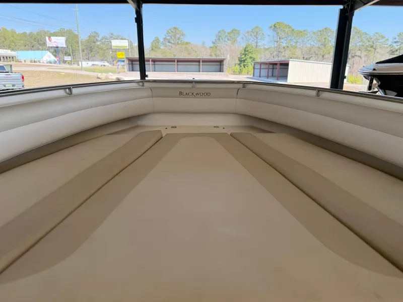Slide: The Image of Interior view of a 2013 Blackwood 27 boat, showcasing spacious seating and sleek design. - 17
