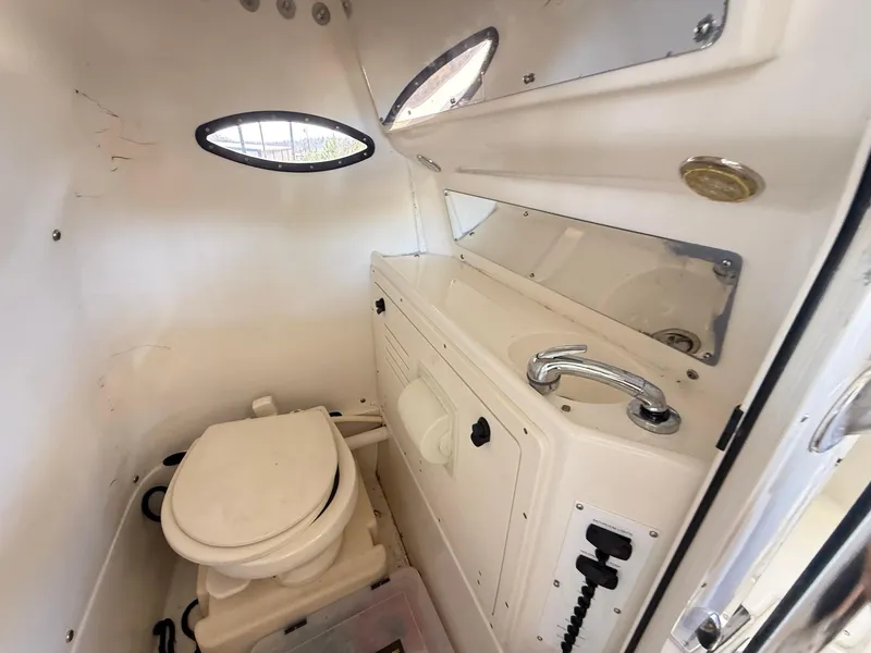Slide: The Image of Compact marine bathroom in a 2013 Blackwood 27 boat, featuring a toilet and sink. - 20