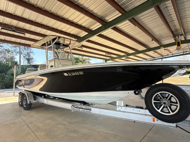 Slide: The Image of 2013 Blackwood 27 boat on trailer under metal roof, side view. - 3