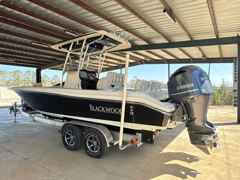 Slide: The Image of 2013 Blackwood 27 boat with Yamaha 300 engine on a trailer in a covered area. - 6