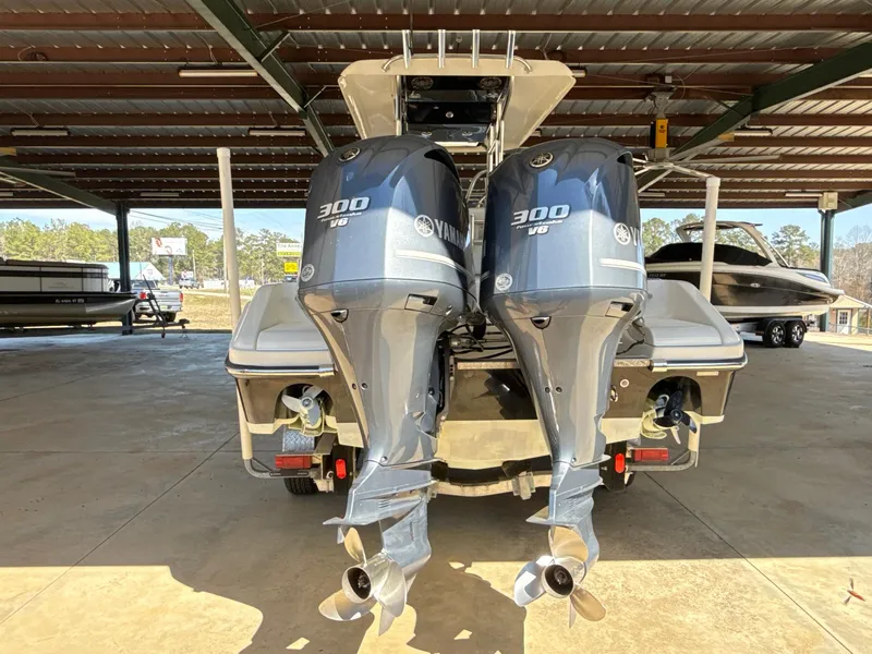 Slide: The Image of Twin Yamaha 300 V6 engines on a 2013 Blackwood 27 boat in a covered storage area. - 7