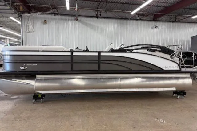 The Image of 2025 Harris Sunliner 230 pontoon boat in a showroom, side view. - 1