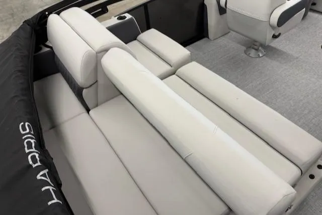 Slide: The Image of 2025 Harris Sunliner 230 boat interior with plush seating and modern design. - 15