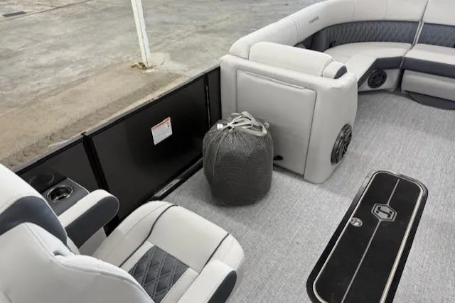 Slide: The Image of Interior of 2025 Harris Sunliner 230 boat with plush seating and modern design. - 16