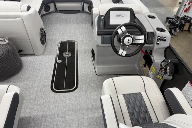 Slide: The Image of 2025 Harris Sunliner 230 boat interior with modern steering and seating. - 18